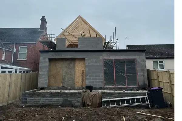 Early stage structure in progress showing brickwork and supports for the extension
