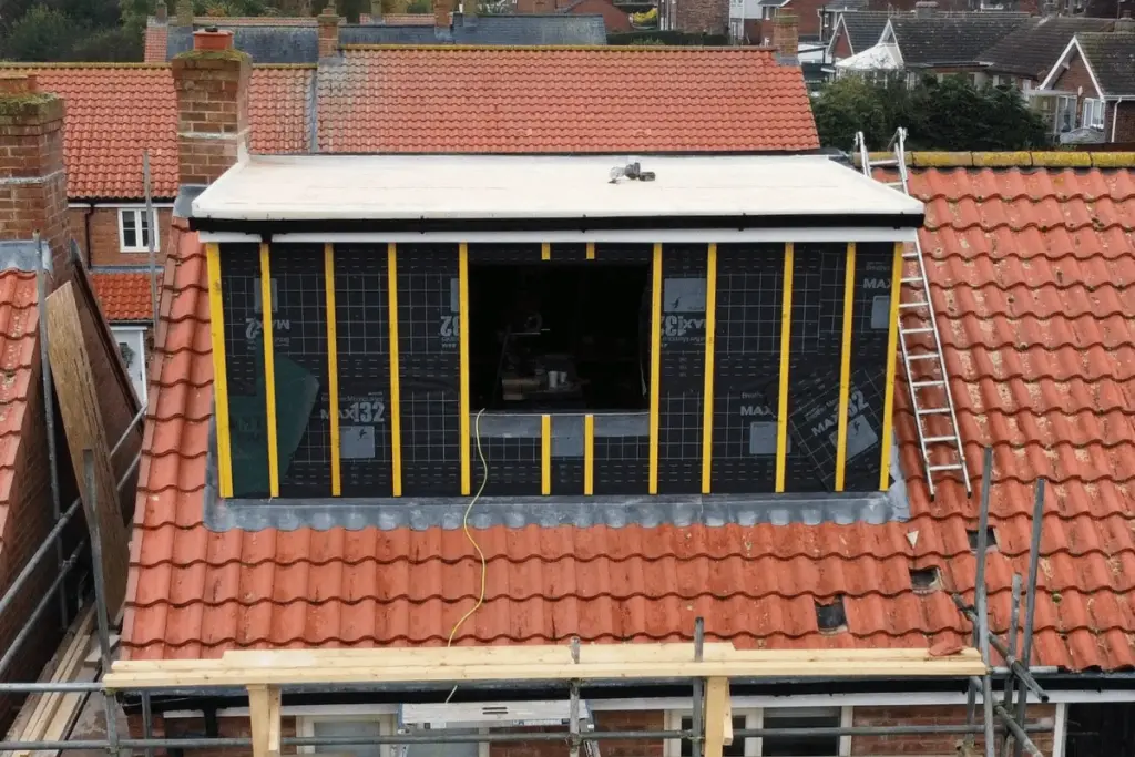 Dormer structure under construction with scaffolding in place at Louth loft conversion project