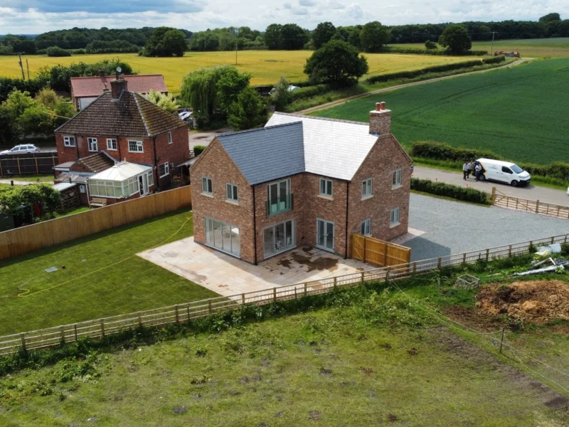 front elevation of new build home in legsby with white framed windows.