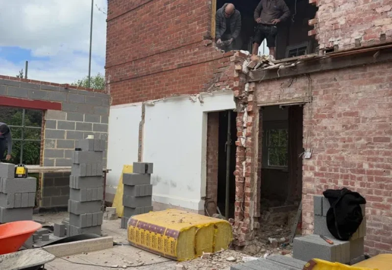 partial residential demolition work on brick property exterior